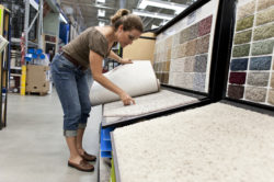 woman selecting carpet to buy