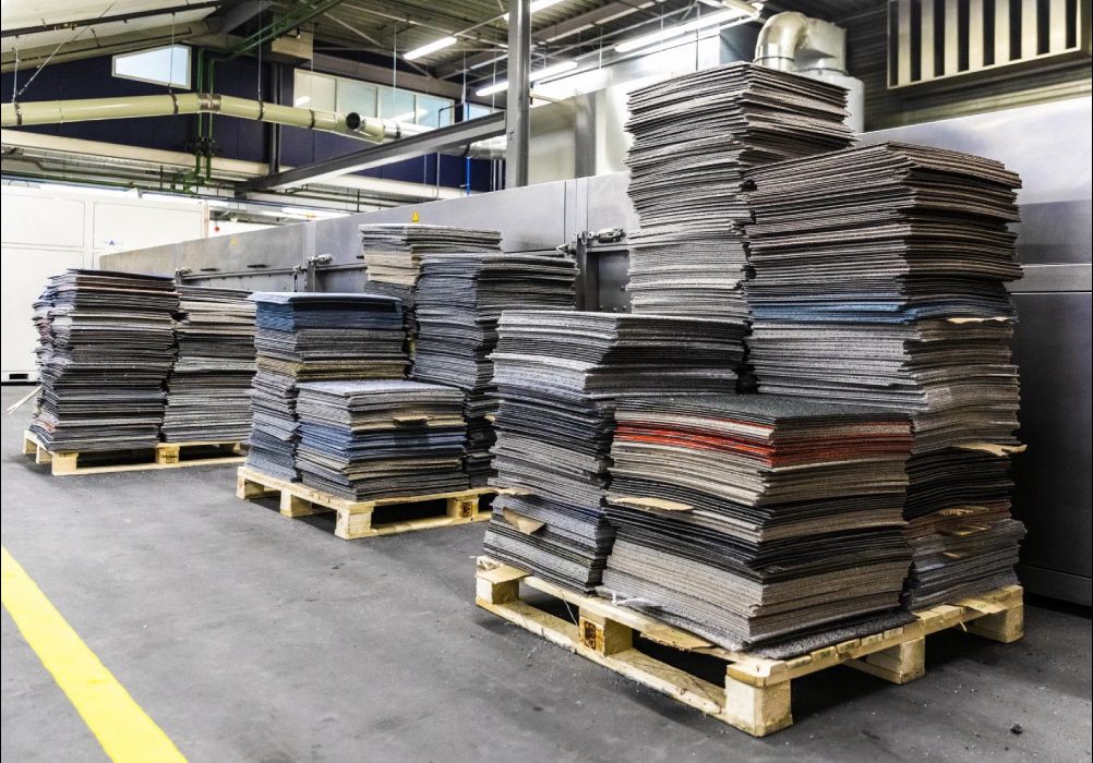 pallets of carpet tile from tear-out in commercial building